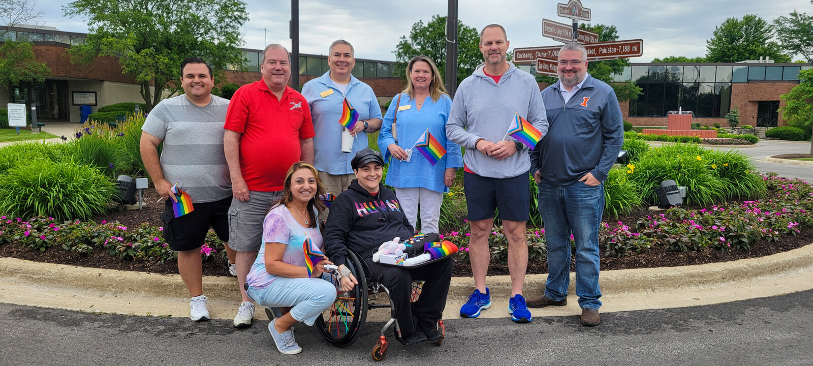 Allaina with Bolingbrook residents and Village officials gathered outdoors after a Pride flag raising